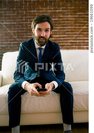 Businessman texting on the couch 19661099
