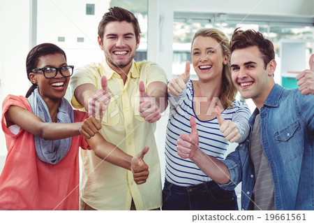 Happy creative team giving the thumbs up Happy creative team giving the thumbs up 19661561