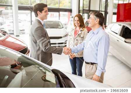 Smiling businessman presenting a car 19661609