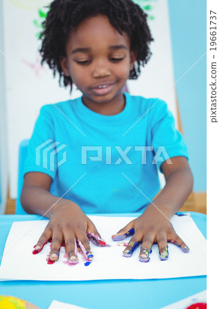 Happy kid enjoying arts and crafts painting 19661737