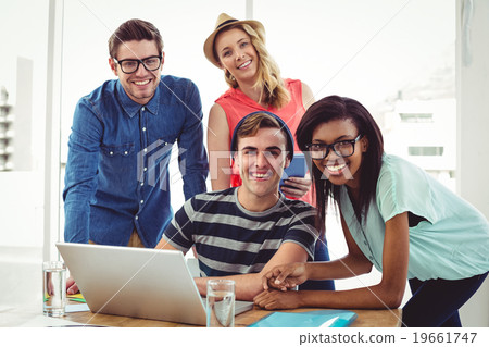 Creative business team working hard together on laptop Creative business team working hard together on laptop 19661747