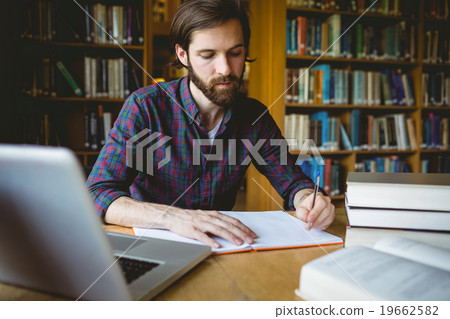 Hipster student studying in library 19662582