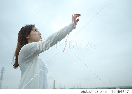 girl reaching up to the sky