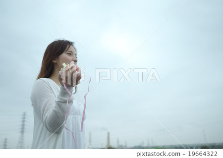 A woman sprinkling a petal A woman sprinkling a petal 19664322