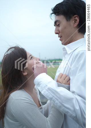 A couple standing outdoors 19664465