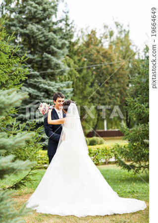 bride and groom kissing in park bride and groom kissing in park 19664649