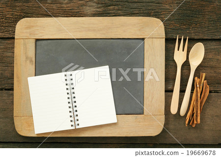 Slate chalkboard and wooden spoon and note book 19669678