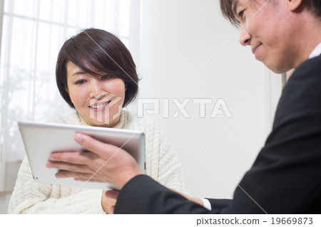 A woman listening to a presentation A woman listening to a presentation 19669873
