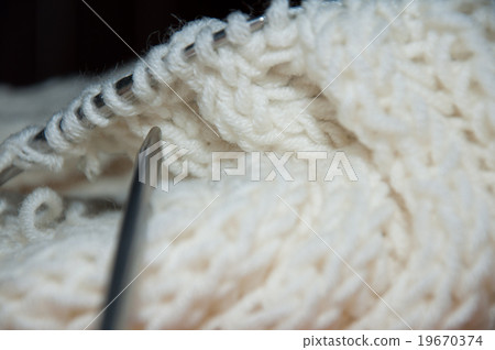 Knit work. White wool scarf and knitting needle Knit work. White wool scarf and knitting needle 19670374