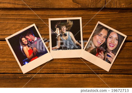 Composite image of instant photos on wooden floor 19672713