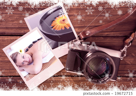 Composite image of glowing young woman with hot stone on her bac Composite image of glowing young woman with hot stone on her bac 19672715