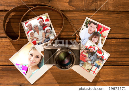 Composite image of children sitting with their family holding christmas boots 19673571