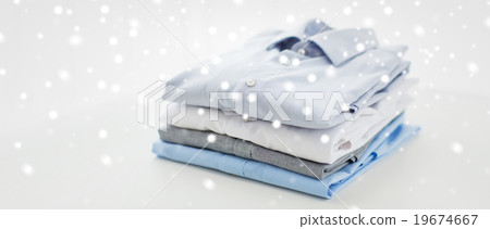 close up of ironed and folded shirts on table 19674667