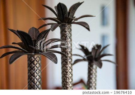 Small palm tree metal decoration on table 19676410