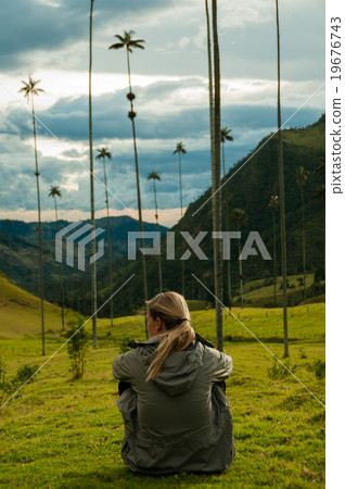Girl with grey jacket sitting on green grass 19676743