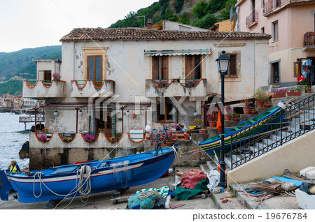 Two blue and green boats sitting on land in small 19676784