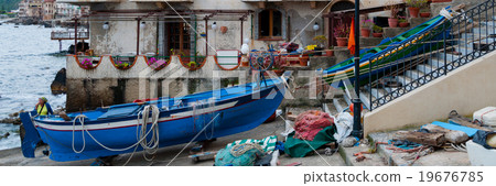 Two blue and green boats sitting on land in small 19676785