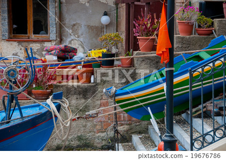 Two blue and green boats sitting on land in small 19676786