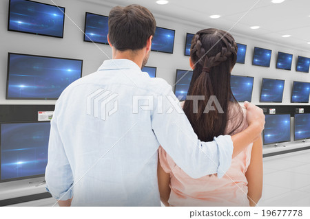 Composite image of attractive young couple standing and looking 19677778