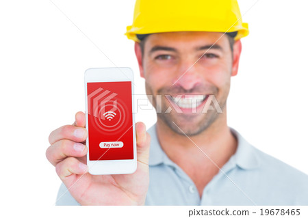 Composite image of portrait of smiling handyman showing smart phone Composite image of portrait of smiling handyman showing smart phone 19678465