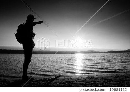Man with hand in the air, sunset at horizon Man with hand in the air, sunset at horizon 19681112