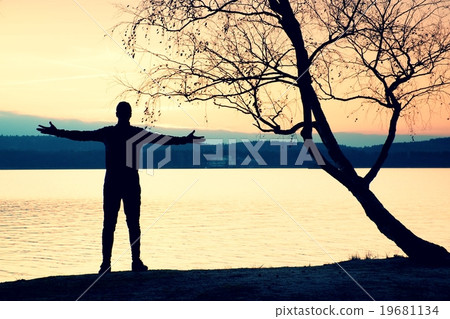 Lone sportsman looking at colorful  sunset  19681134