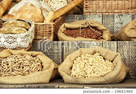 Pasta and pastries in bags on the wooden board 19681460