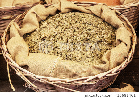 Dried ground fenugreek in the wicker basket 19681461