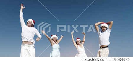 Two couple celebrating on the beach on Christmas Concept 19684985