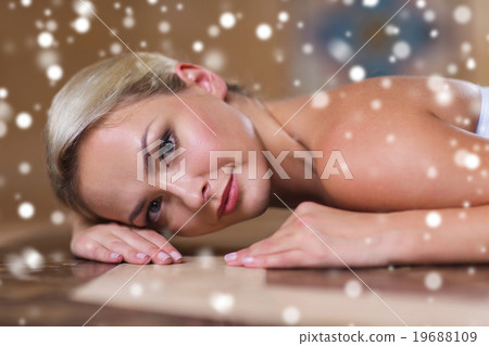 young woman lying on hammam table in turkish bath 19688109