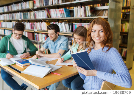 happy students reading books in library happy students reading books in library 19688709