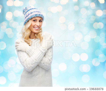 smiling young woman in winter hat and sweater 19688878