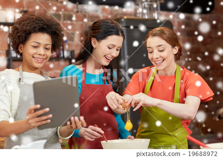 happy women with tablet pc in kitchen 19688972