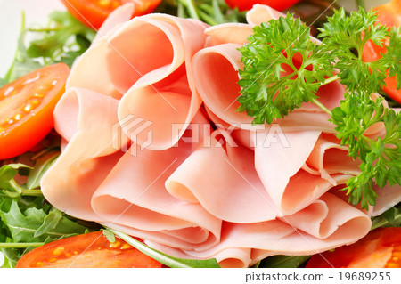 Sliced ham with arugula leaves and tomatoes Sliced ham with arugula leaves and tomatoes 19689255