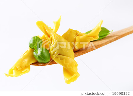 Stuffed pasta on wooden spatula Stuffed pasta on wooden spatula 19690332