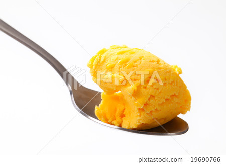 Yellow ice cream on a spoon 19690766