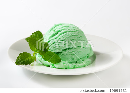 Scoop of green ice cream on plate 19691381