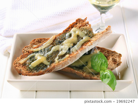 Toasted pesto bread with cheese 19692247