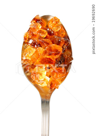 Brown rock sugar on spoon Brown rock sugar on spoon 19692690