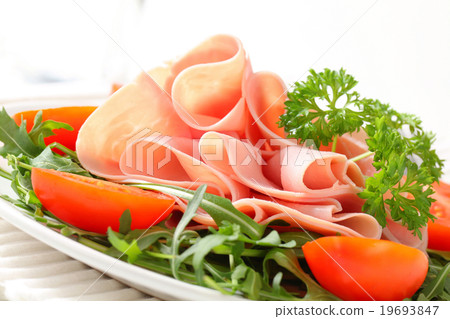 Sliced ham with arugula leaves and tomatoes Sliced ham with arugula leaves and tomatoes 19693847