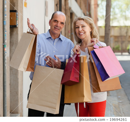 Aged couple with purchases Aged couple with purchases 19694261