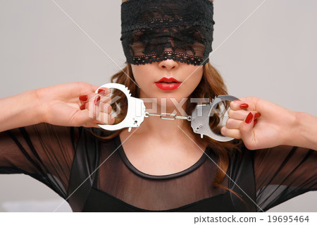 Sexual woman holding handcuffs. Sexual woman holding handcuffs. 19695464
