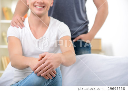 Loving homosexuals sitting on the sofa  19695538