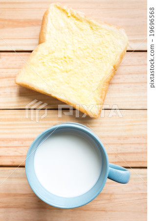 bread and milk on wood plate bread and milk on wood plate 19696568
