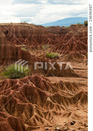 Big red sandstone rock formation in hot dry desert Big red sandstone rock formation in hot dry desert 19696997
