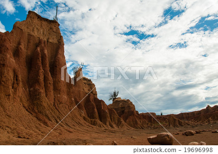 Big orange sand stone cliff in dry hot tatacoa Big orange sand stone cliff in dry hot tatacoa 19696998