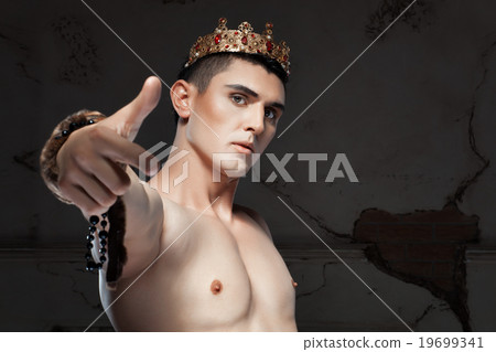 Young man with crown head pointing her finger. 19699341