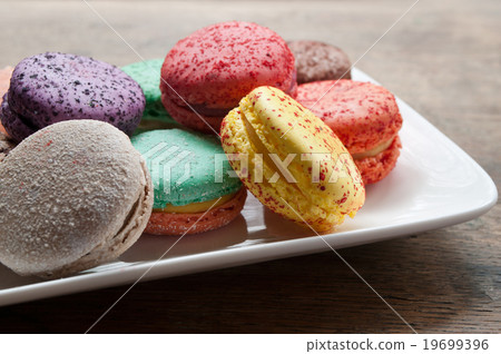assortment of french macarons on wooden background assortment of french macarons on wooden background 19699396