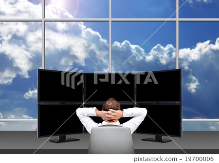 Relaxing businessman who is sitting in front of trading station 19700006