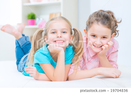 Pretty sisters having fun at home  19704836